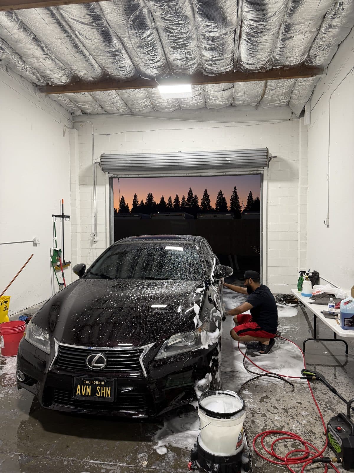 Foam wash on a black Lexus GS, front grille and headlights